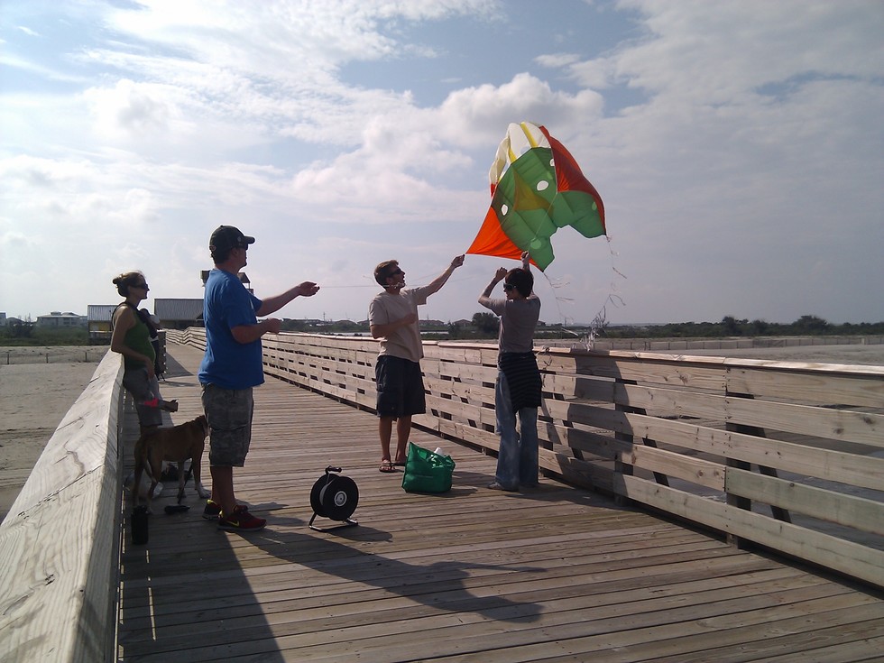 Flying a kite on the pier at Grand Isle